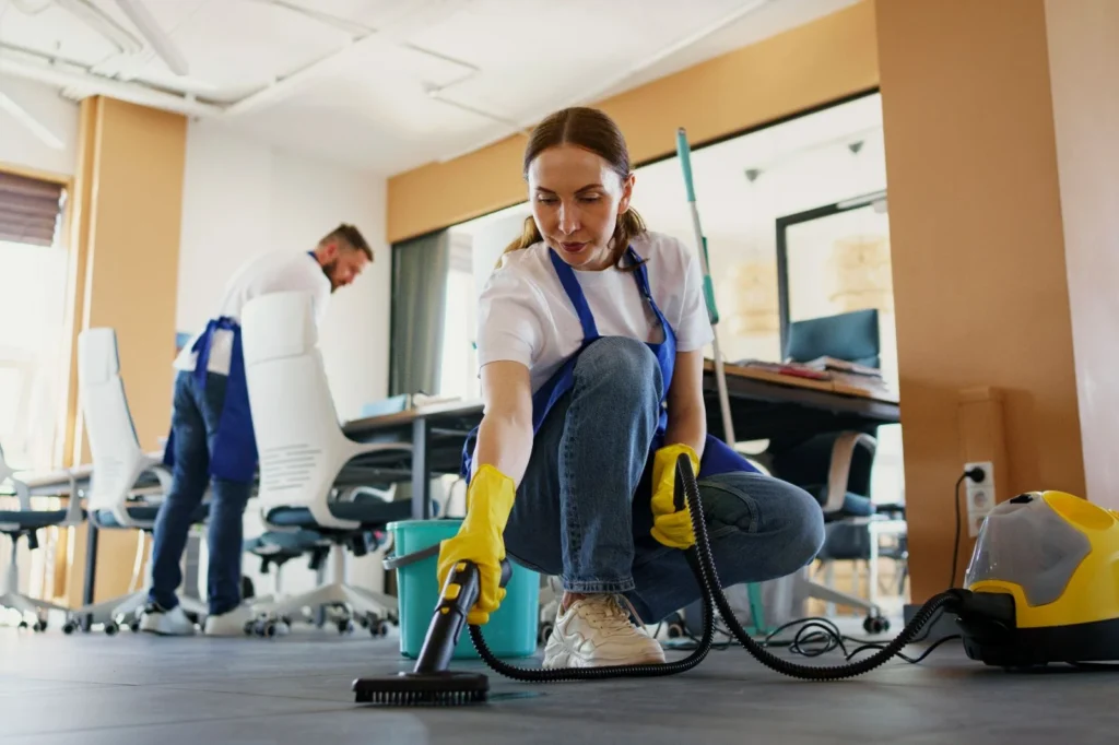 professional cleaning service person using vacuum cleaner office 1